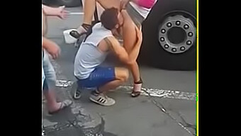 A Man Performing Oral Sex On A Woman'S Genitals In A Public Setting