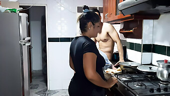 A Mature Brunette Woman Performs Oral Sex On A Young Man In The Kitchen