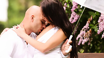 A Loving Pair Engages In Outdoor Intimacy On A Park Bench